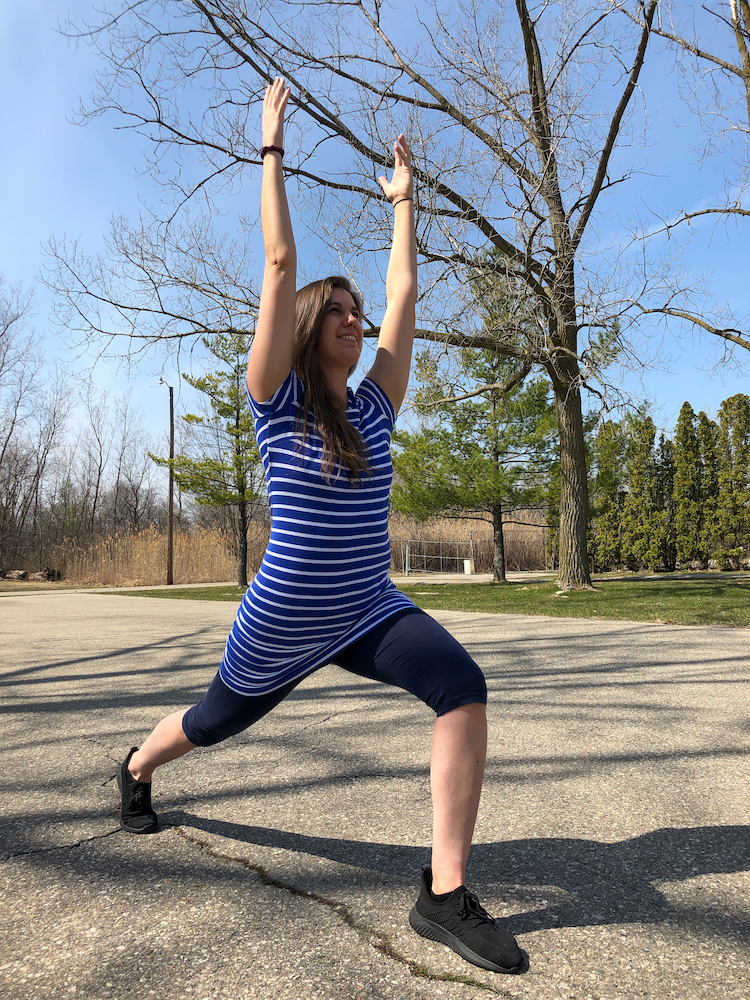 A woman doing a yoga pose outside.